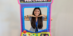 Maili smiles in a retor Arcade-style photo stand-in.