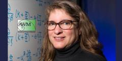 Carol Woodward in front of a whiteboard covered in math notations