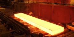 hot slab of metal on a conveyor belt