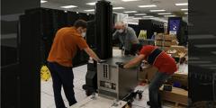 three people install Cerebras components in the HPC machine room