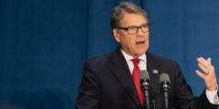Rick Perry speaking in front of an American flag