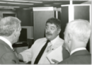 black and white photo of three scientists talking