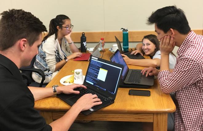 students work as a team at a hackathon